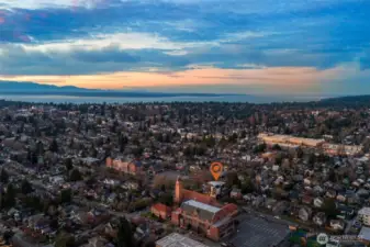 Aerial view highlighting the home's proximity to Green Lake and breathtaking panoramic vistas of the Olympic Mountains and Puget Sound.
