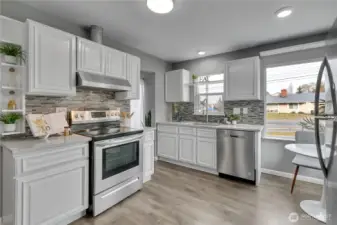 Updated kitchen with beautiful white cabinetry, designer tile backsplach & stainless appliances!