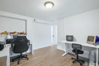 Versatile lower-level flex space with built-in desks and updated flooring. Ideal for office, gaming, another bedroom or creative use.