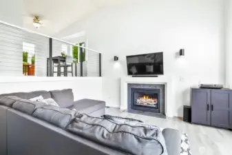 Vaulted ceilings, gas fireplace and large arched windows fill the living area with natural light. Great room layout ideal for relaxing or entertaining.