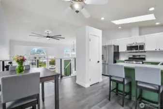 Open-concept layout connects kitchen and dining to vaulted living space below. Great for entertaining and everyday living.