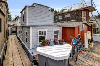 Dock side with deck space, storage, and a bicycle rack.