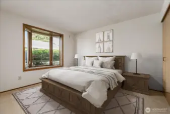 Main floor primary suite virtually staged
