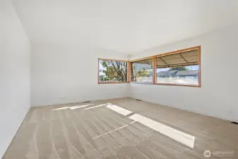 Living room has big windows to bring in all the light!