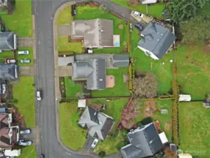 Aerial view showcasing the generous lot, large backyard, and detached shop/garage — nicely positioned on a quiet Covington street with plenty of space to spread out.