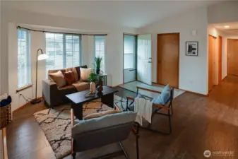 As you enter the front door, there is a coat closet, Bay style windows bringing in loads of natural light, Elevated ceilings and wood floors.