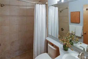 Primary bathroom featuring a walk-in tile shower and clean, updated finishes — a comfortable and practical ensuite for everyday living.