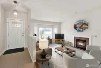 Entryway and living room with a lot of light and gas fireplace. Virtually staged.