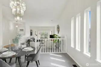 Dining room open to living room, virtually staged.