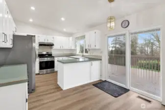 Nice open kitchen with a lot of cabinet space. The new glass slider opens to the large deck. Enjoy the views of the bay.