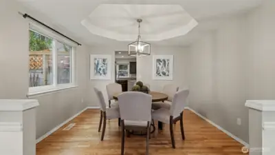 Elegantly designed dining room features hardwood floors and recessed ceiling