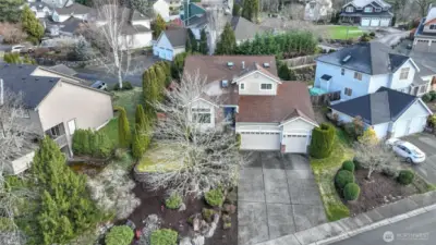 Three-car garage with tons of storage and long driveway provide ample parking. Welcome to the Highlands