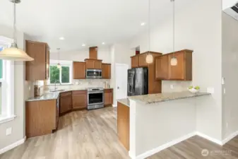 Granite Kitchen countertop and tile backsplash. connected to dining room.