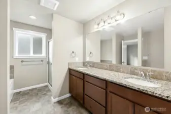 Primary Bathroom with double vanity, walk-in shower, soaking tub, and walk-in closet