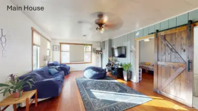 Living room in the main house with original wood flooring