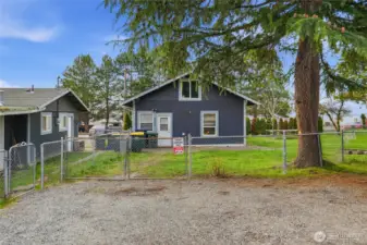 Looking at the back side of both homes on the property and the rear parking area.