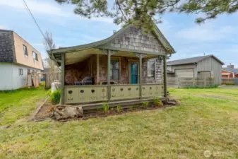 covered front porch protects you from the elements. Shingle siding adds coastal charm.
