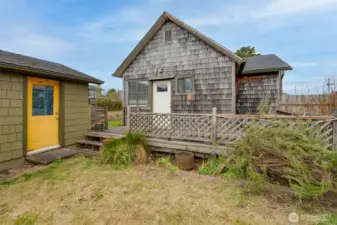 Back porch overlooking the back and side yard with access to the garage.
