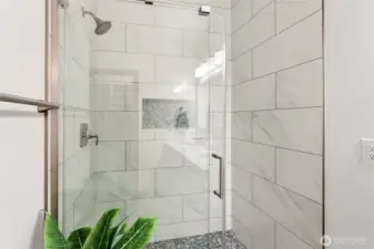 Tiled shower surround w/ glass enclosure, and new fixtures.