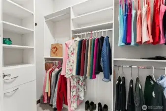 Generous walk-in closet complete with an organized storage system.