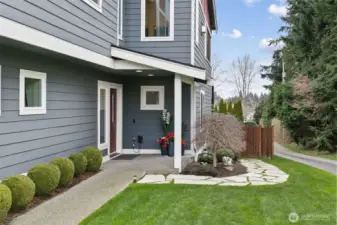An inviting entry and a meticulously landscaped yard create exceptional curb appeal.