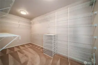 The large walk-in closet is outfitted with organizers to make the most of every inch of space.