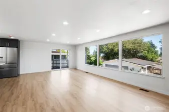 Huge picture windows brings tons of natural light to this bright and open living area