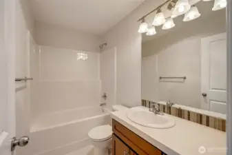 A full bathroom and upstairs laundry room across the hall add convenience to everyday living.