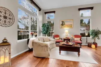 Grand foyer/formal living room with vaulted ceilings, skylights, and hardwood floors.