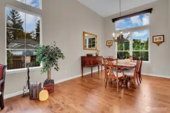 Formal dining room with hardwood floors and multiple windows