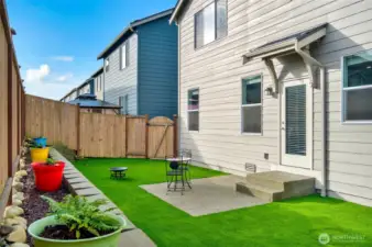 Beautiful, clean-looking yard with professionally installed turf and a new retaining wall that enhances both style and function.