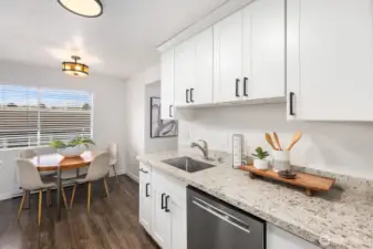 Updated chef's kitchen leads to formal dining area.