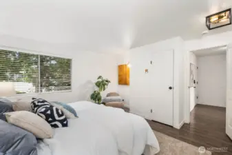 Spacious primary bedroom with reading/vanity nook and plenty of storage.