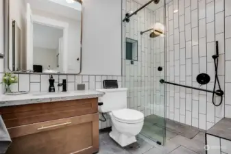 A divine primary bath with luxury fixtures and custom tile.