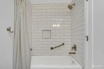 Cast iron tub surrounded by timeless and classic subway tile.
