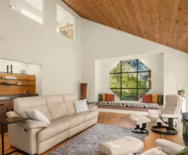 The vaulted ceiling floods to the upper loft. The window seat is an incredible place for basking in the sunshine or conversations.
