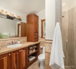 Solid cherry cabinets are extended to the primary bathroom. One side of the primary offers this 3/4 bathroom. There is also a full bath with soaking tub!