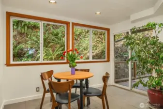 The sweet kitchen nook has a slider to the wrap-around deck. This informal nook is perfect for morning coffee.