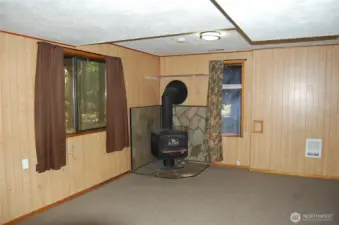 Walk out basement has large family room with a woodstove.