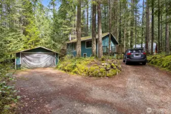 Street view of home and detached carport.