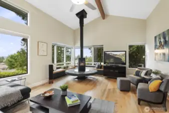 Adorable living room with lots of windows looking out at the Olympic Mountains and even peek-a-boo sound views.