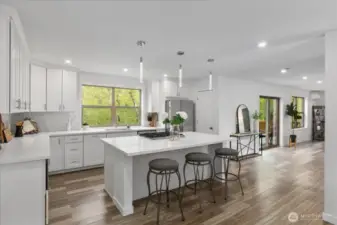 The oversized island offers seating for guests in this Chefs dream kitchen.