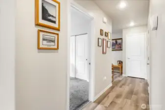 The vinyl flooring runs through the hallways. The door in front of you is the coat closet to the "front" door.