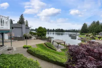 Property features level waterfront with patio and gazebo, sport court, dock, boat lift, bulkhead, and outbuildings.  Perfect for embracing lake life.