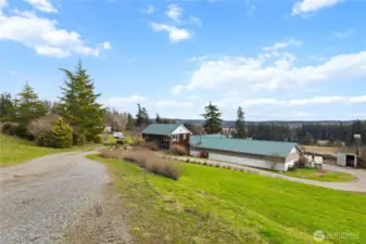 Expansive country property with a charming farmhouse, outbuildings, and sweeping territorial views.