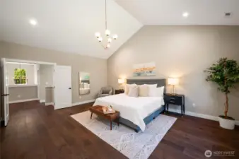 The massive primary room with vaulted ceilings.