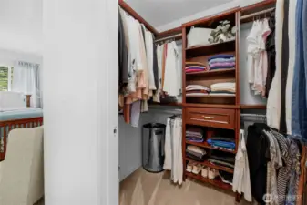 spacious walk-in closet with gorgeous custom shelves within the primary bedroom-