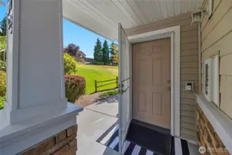 charming entry-this condo is an end unit and it is surrounded by a grassy area and backed by trees creating a ton of privacy