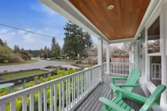 The charming front porch was added for leisurely mornings with coffee, overlooking the incredibly landscaped front yard and beautiful spring blooms.