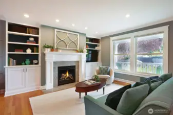 The living room had a glow up with a new direct vent fireplace, marble hearth, restored mantle, and custom built-in cabinetry with gracefully concealed media connections.